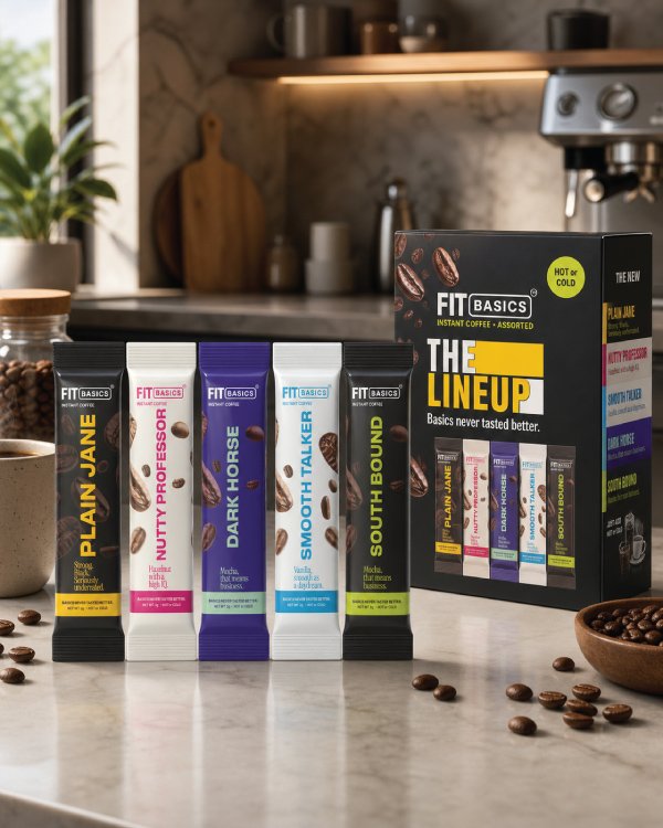 Premium coffee beans falling into a dark ceramic bowl alongside a pour-over coffee maker in a bright modern kitchen