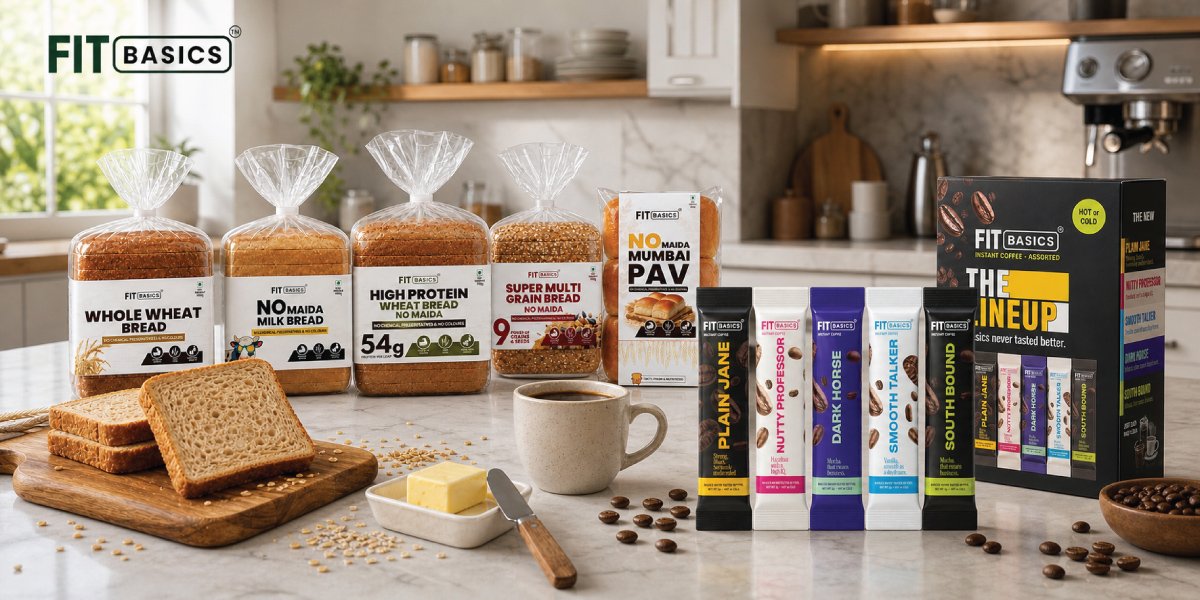 Artisanal sourdough bread loaves and ceramic cups of coffee arranged on a warm cream surface with soft natural lighting